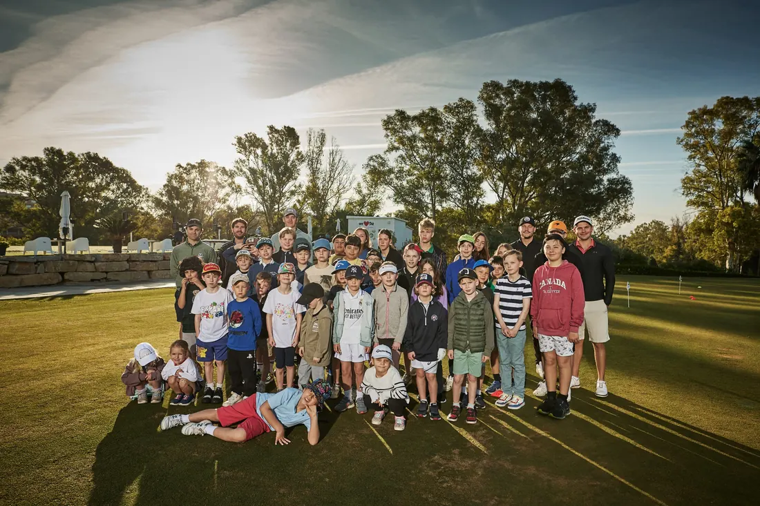 PG Golf and Sports Academy junior group photo on the practice green